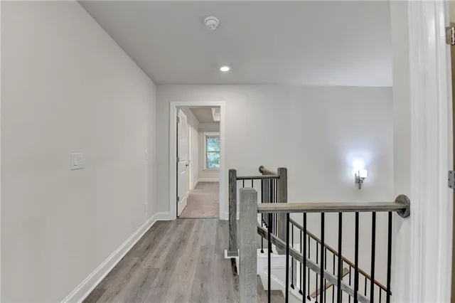 a view of hallway with wooden floor