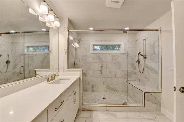 a bathroom with a shower sink and mirror