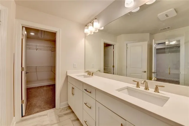 a bathroom with a double vanity sink and a mirror