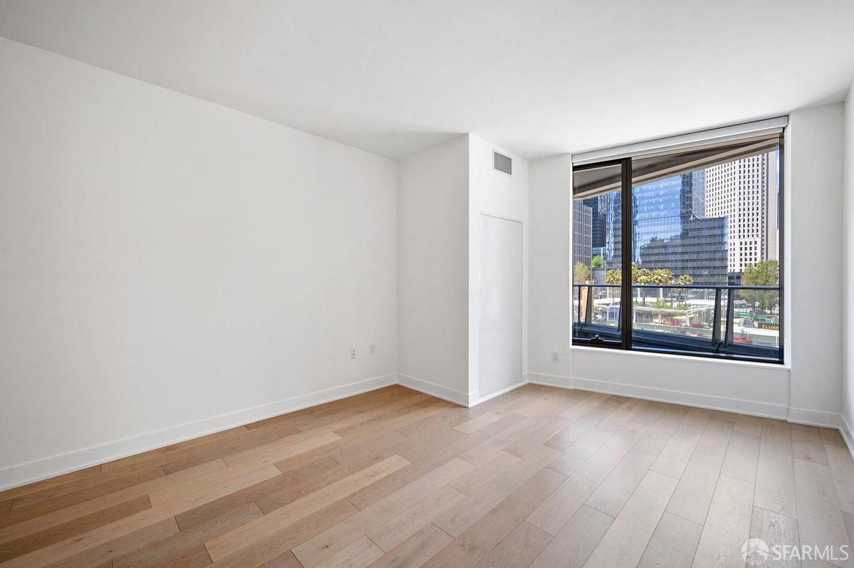 318 Main Street, Unit 4E San Francisco, CA 94105 - Photo 14 of 50 a view of an empty room with wooden floor and a window