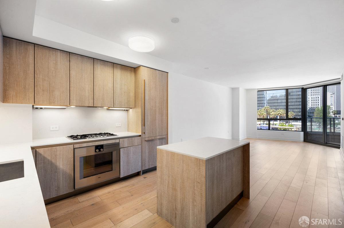 318 Main Street, Unit 4E San Francisco, CA 94105 - Photo 2 of 50 a kitchen with stainless steel appliances granite countertop a stove a sink and a microwave