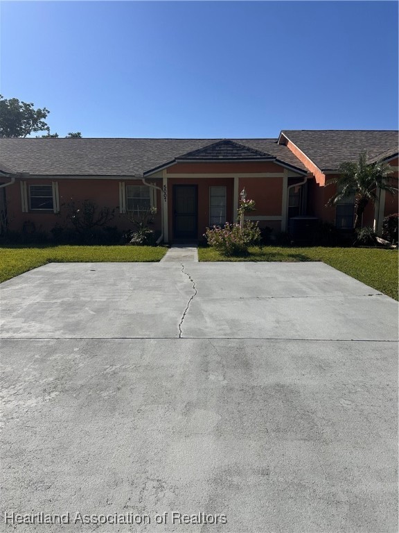 5007 Granada Boulevard Sebring, FL 33872 - Photo 1 of 15 a front view of a house with a yard and garage