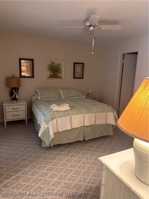 5007 Granada Boulevard Sebring, FL 33872 - Photo 7 of 15 a bedroom with a bed and a lamp