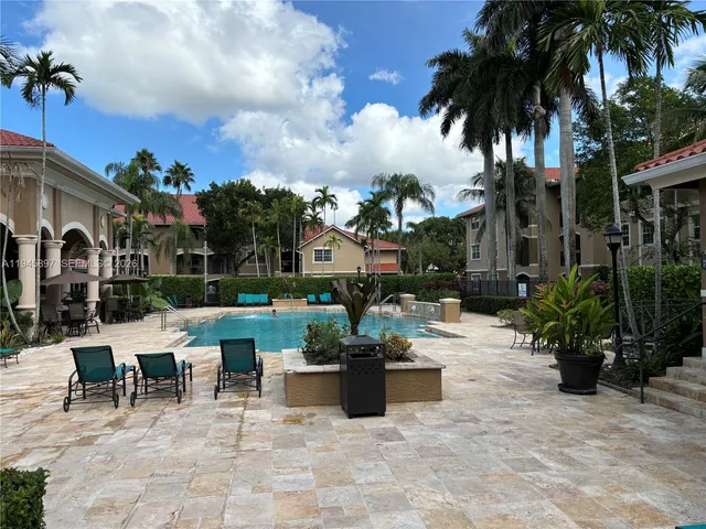 a view of a patio with dining table and chairs potted plants
