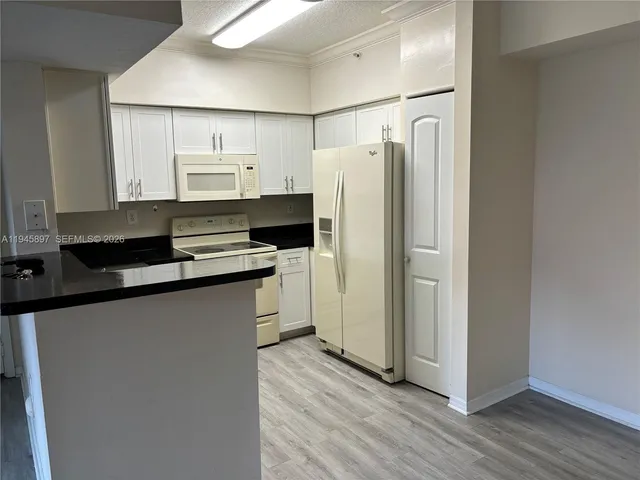 a kitchen with stainless steel appliances a refrigerator and a stove top oven