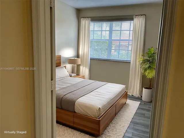 a bed sitting in a bedroom next to a window
