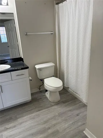 a bathroom with a toilet a sink and a mirror