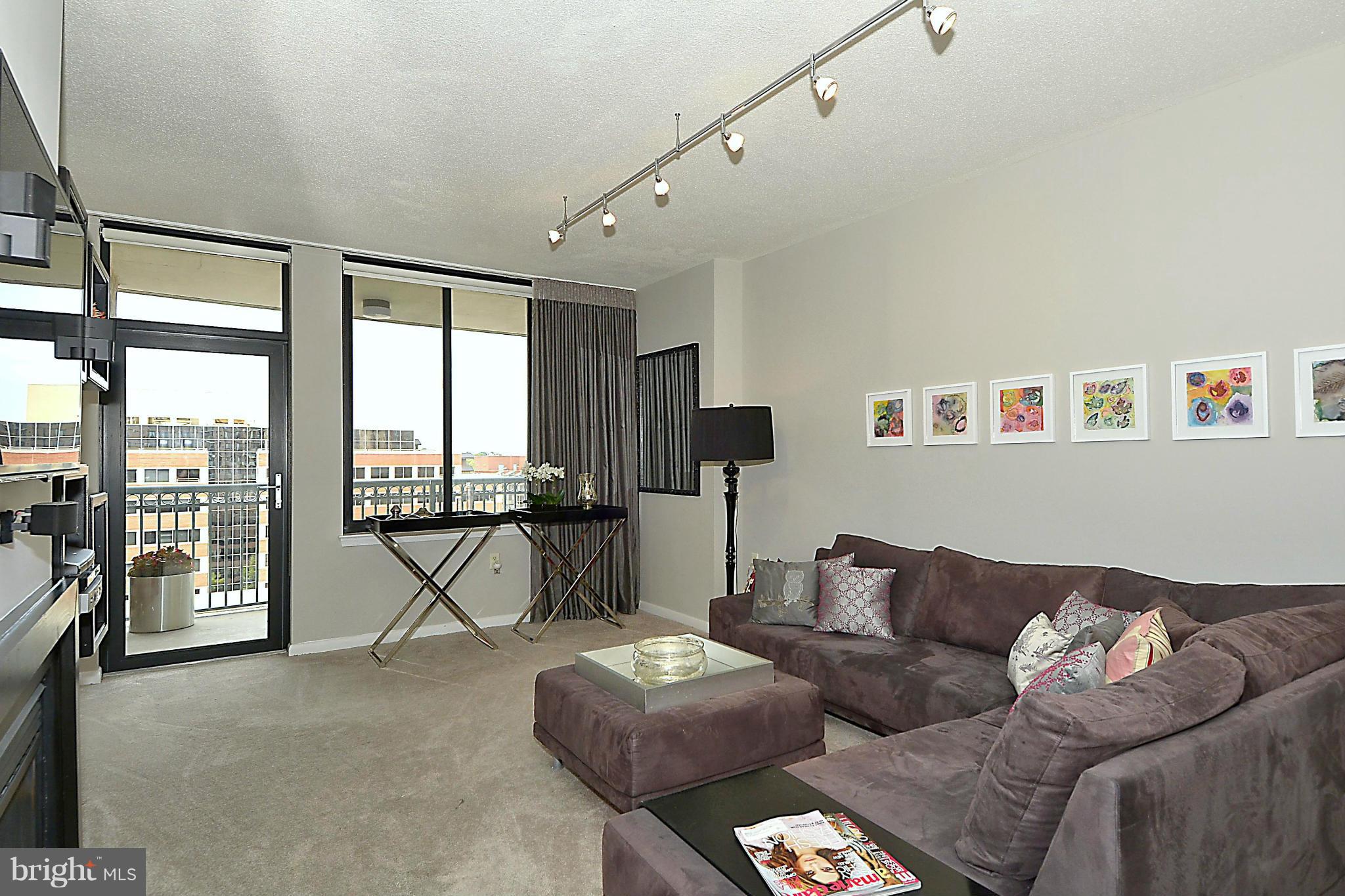 851 North Glebe Road, Unit 915 Arlington, VA 22203 - Photo 2 of 30 a living room with furniture and a floor to ceiling window