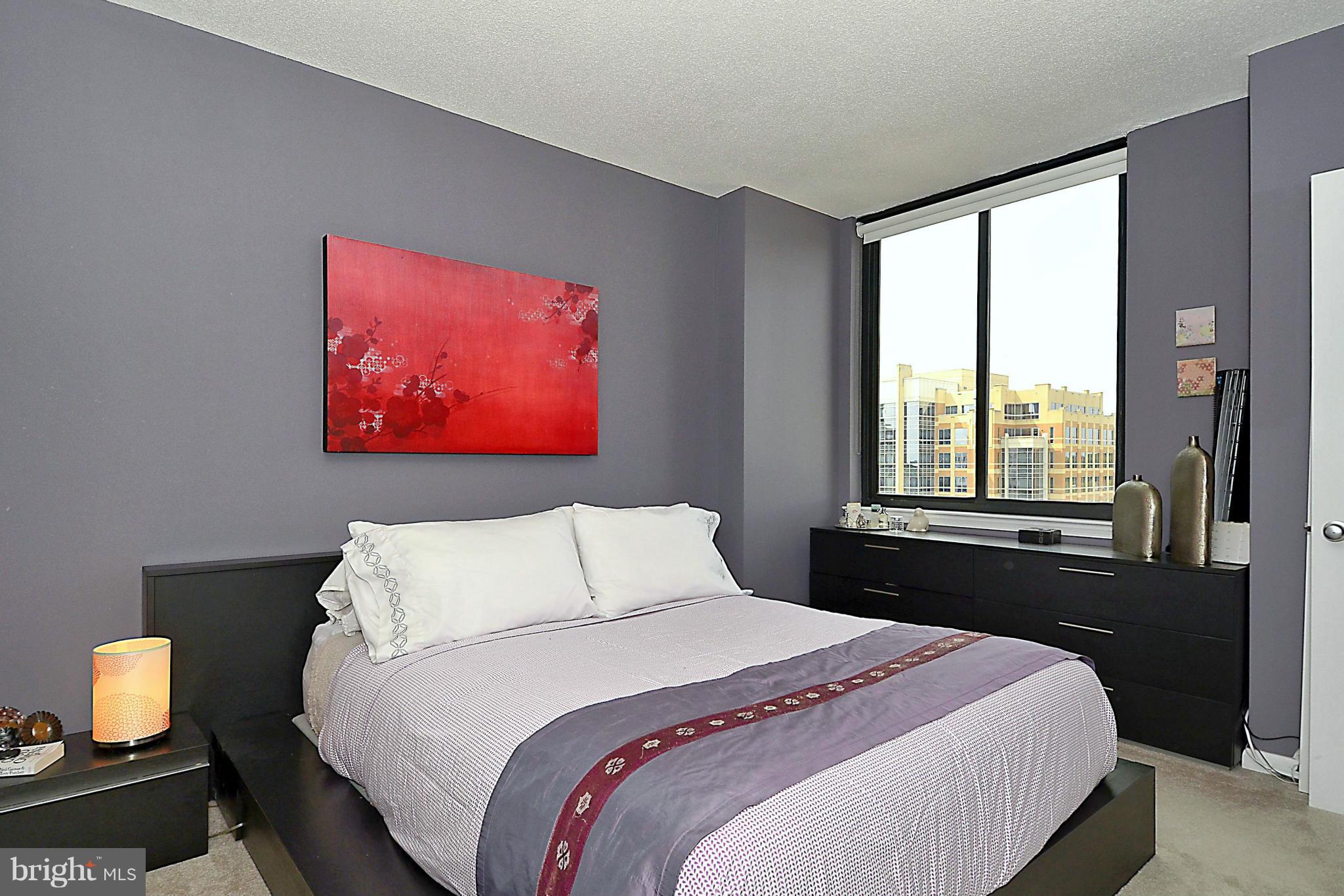 851 North Glebe Road, Unit 915 Arlington, VA 22203 - Photo 12 of 30 a bedroom with a bed and a lamp next to a window