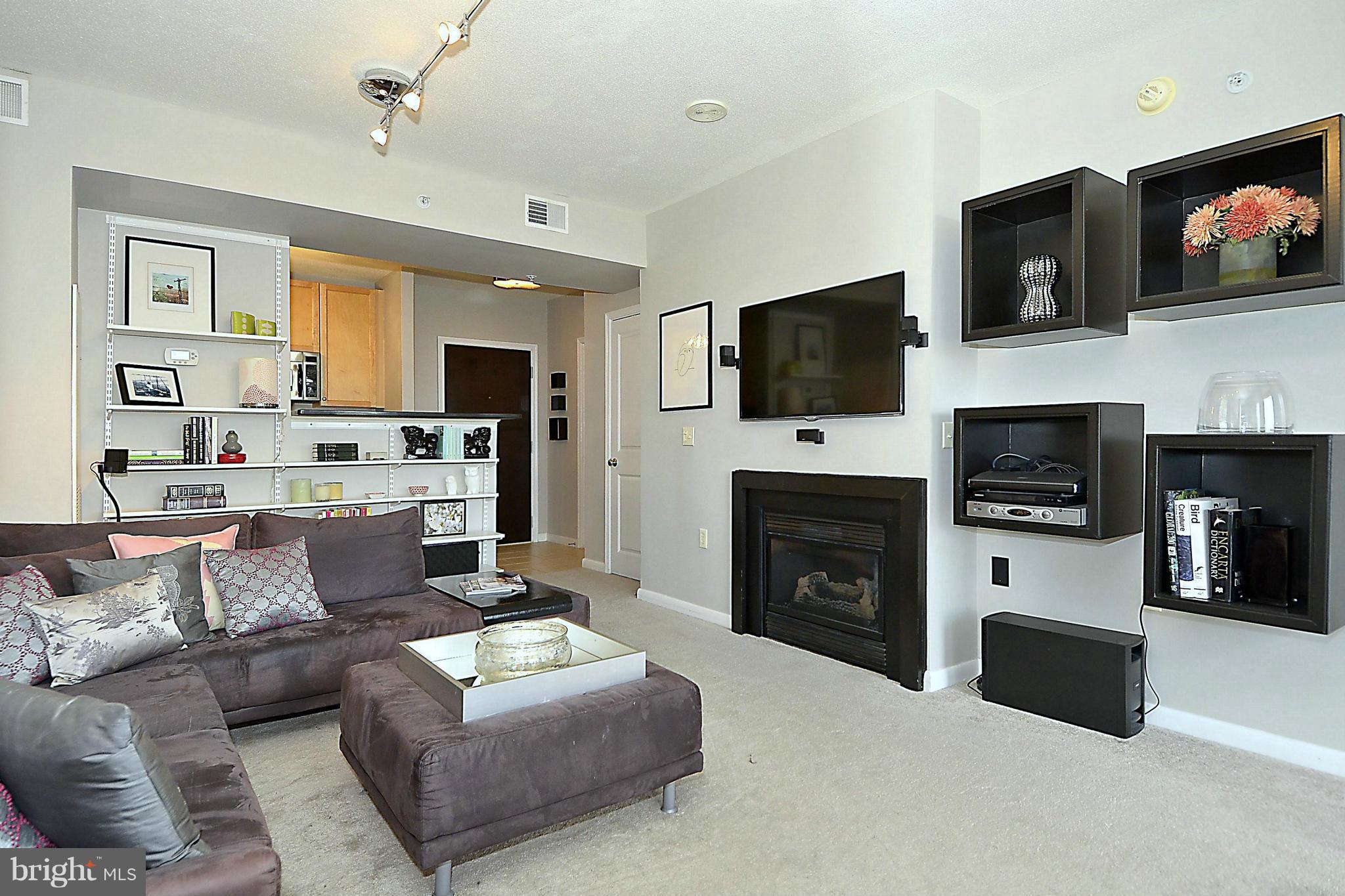 851 North Glebe Road, Unit 915 Arlington, VA 22203 - Photo 4 of 30 a living room with fireplace furniture and a flat screen tv