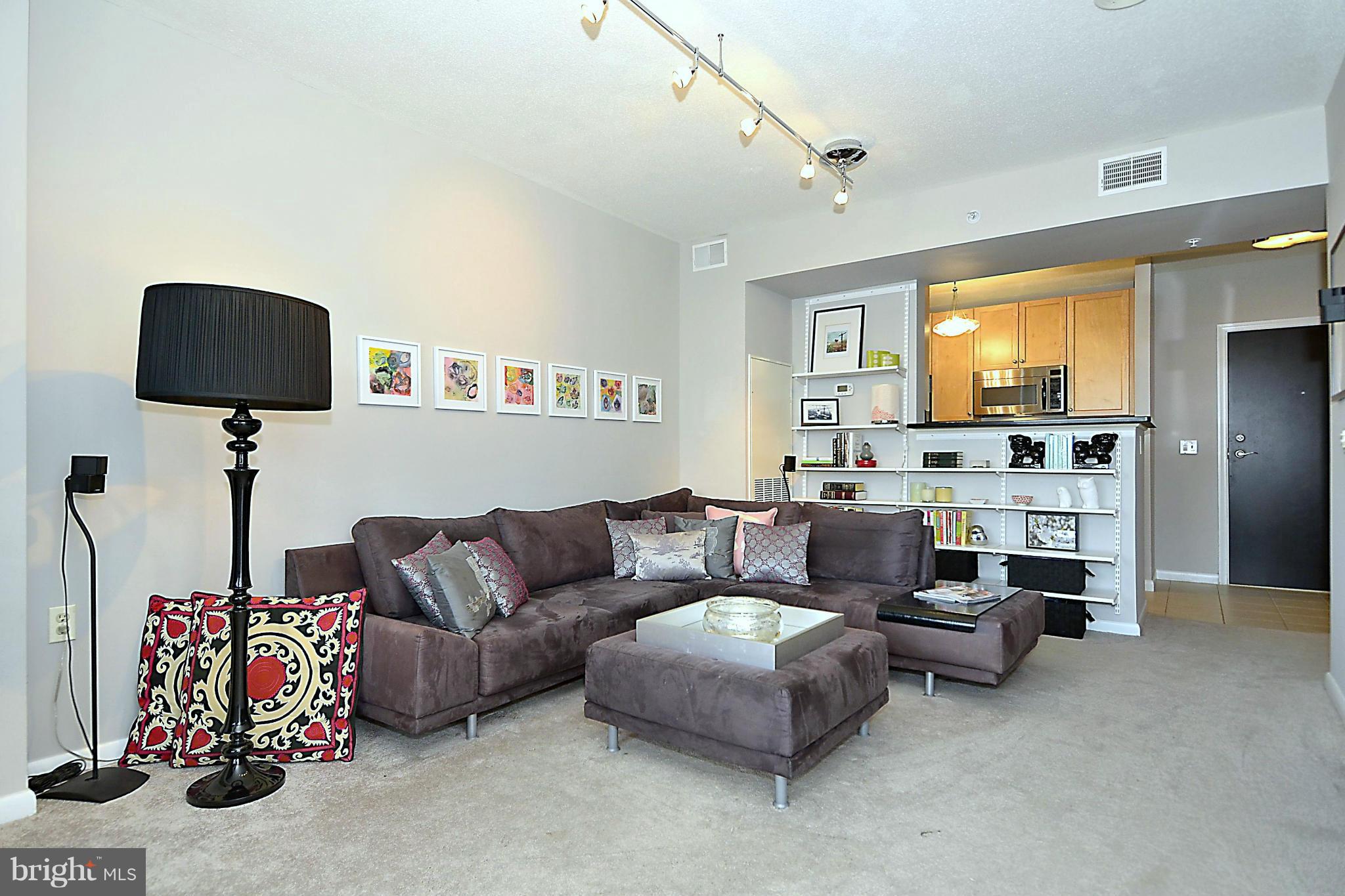 851 North Glebe Road, Unit 915 Arlington, VA 22203 - Photo 5 of 30 a living room with furniture and a flat screen tv