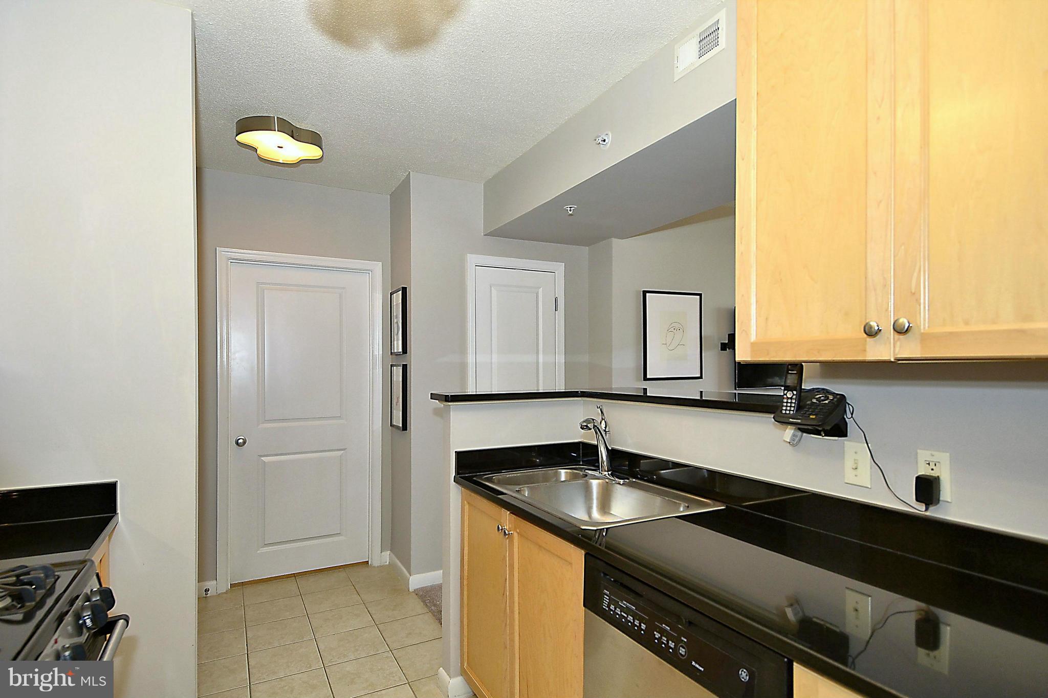 851 North Glebe Road, Unit 915 Arlington, VA 22203 - Photo 8 of 30 a kitchen with a sink and cabinets