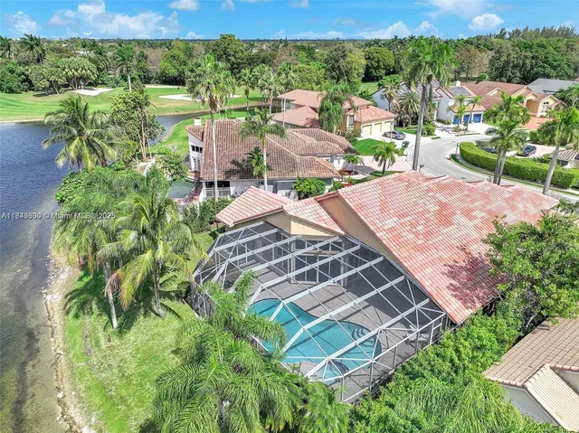 an aerial view of a houses with outdoor space and ocean view