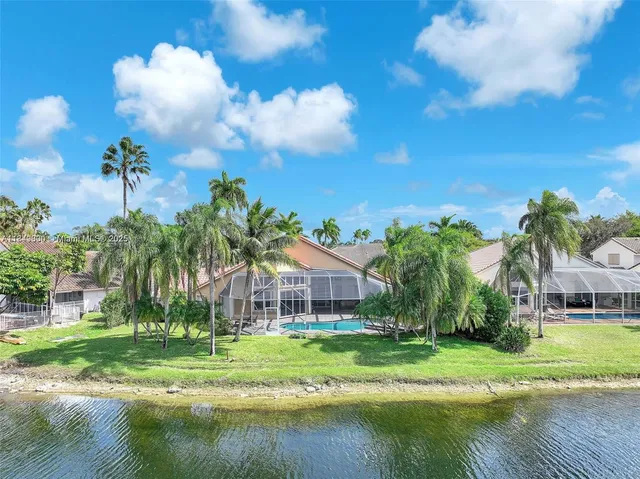 a large kitchen with stainless steel appliances granite countertop a large counter top and stainless steel appliances