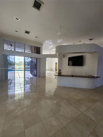 a view of a kitchen with furniture and an empty room