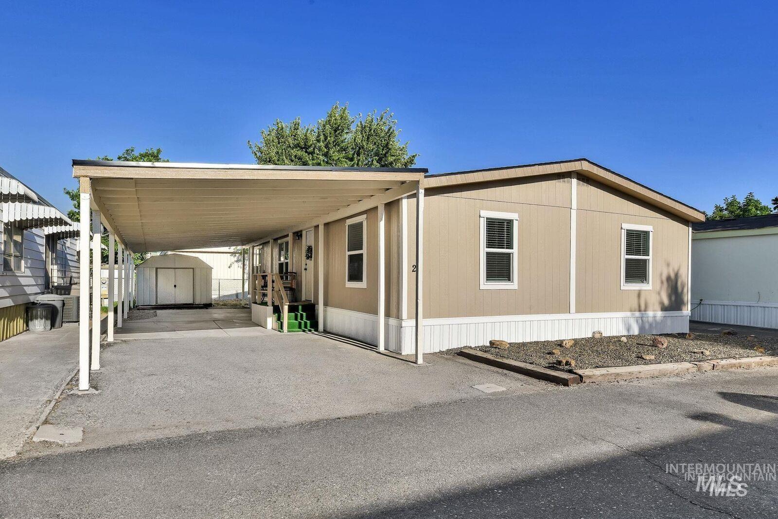 3249 Cherry Lane, Unit 23 Boise, ID 83705 - Photo 2 of 11 Manufactured / mobile home with a storage unit, a carport, and driveway