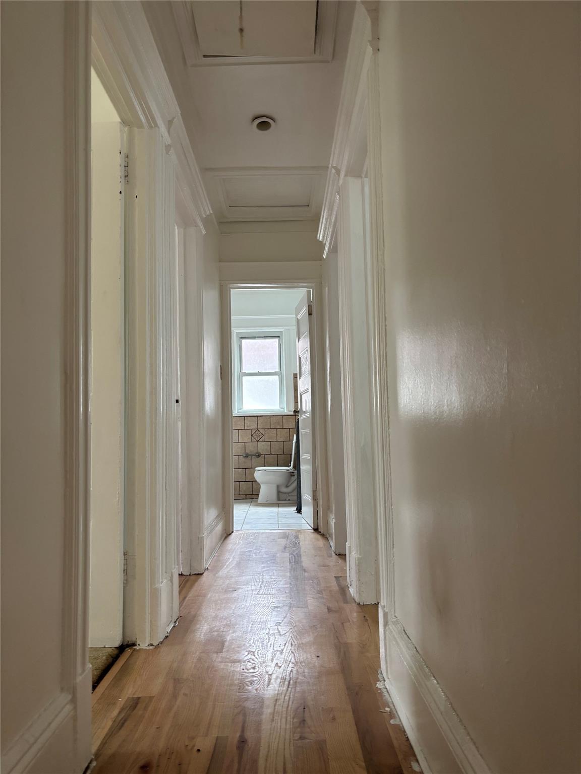 219-06 101st Avenue Queens, NY 11429 - Photo 11 of 19 a view of a hallway with wooden floor