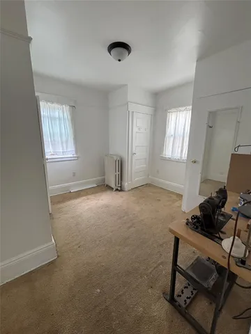 a livingroom with workspace and a window