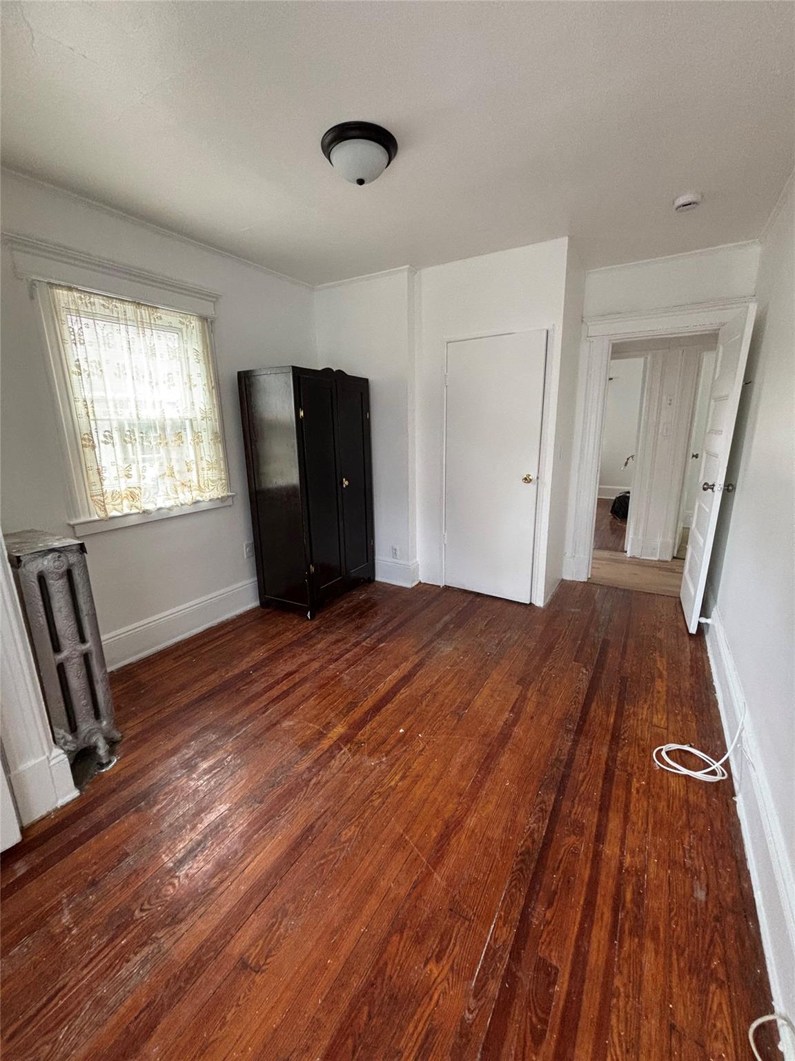 219-06 101st Avenue Queens, NY 11429 - Photo 15 of 19 a bedroom with a bed and wooden floor