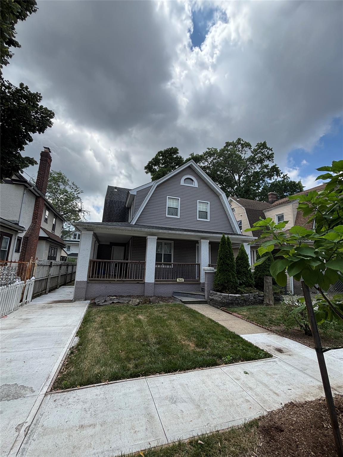 219-06 101st Avenue Queens, NY 11429 - Photo 2 of 19 a front view of a house with a garden