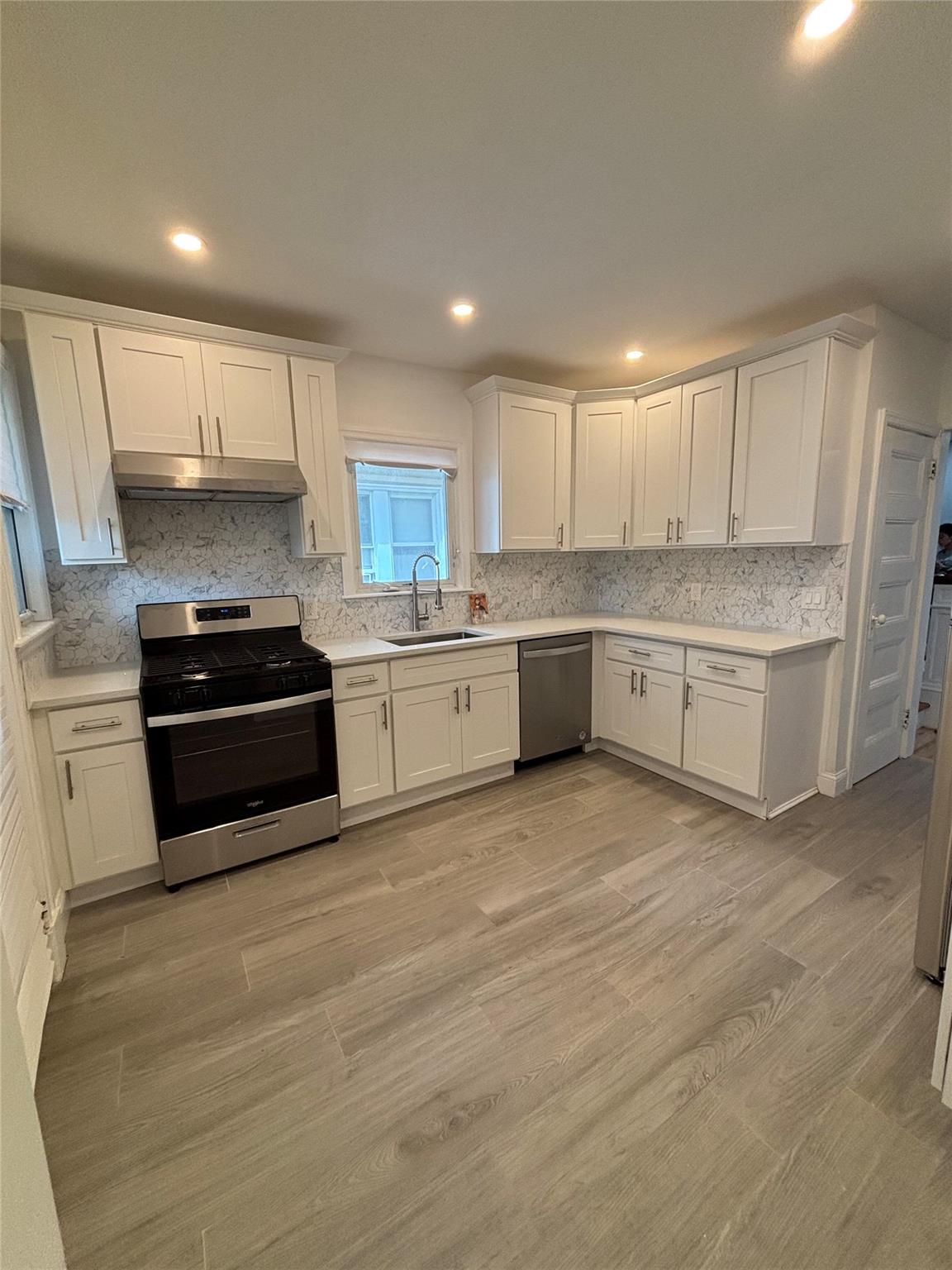 219-06 101st Avenue Queens, NY 11429 - Photo 4 of 19 a kitchen with granite countertop a stove and cabinets
