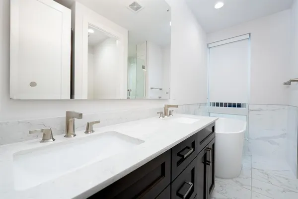 a bathroom with a sink double vanity and a mirror
