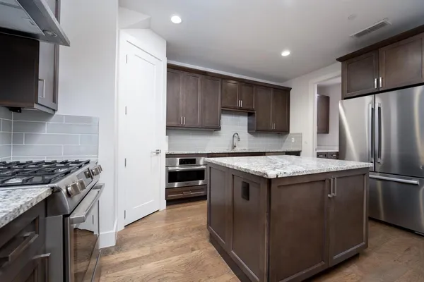 a kitchen with a stove and a refrigerator