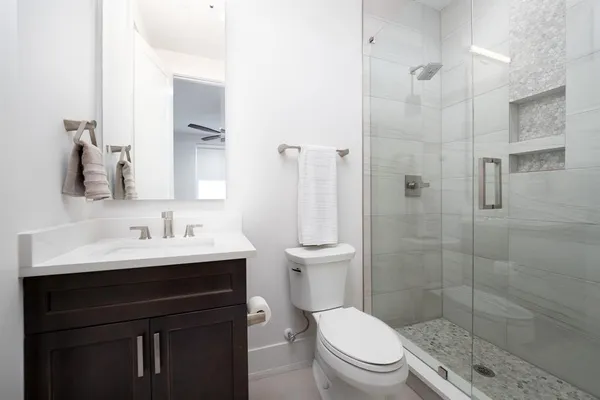 a bathroom with a sink toilet and shower