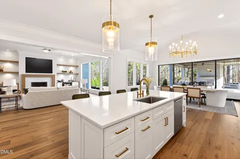 a view of a dining room with furniture a chandelier and wooden floor