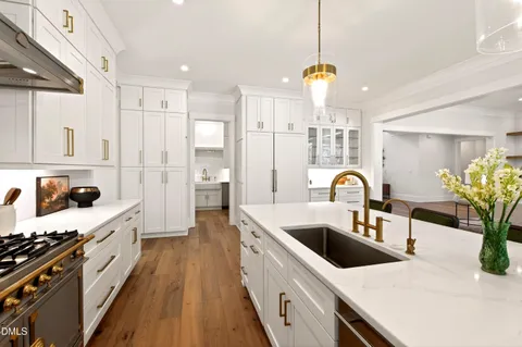 a kitchen with a cabinets and wooden floor
