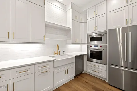 a bathroom with a sink a toilet a mirror and shower