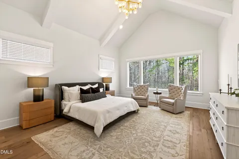 a view of empty room with wooden floor and window
