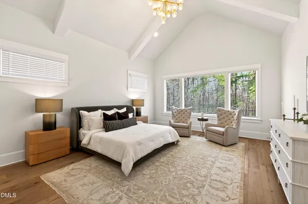 a view of empty room with wooden floor and window