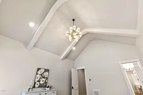 a view of a hallway with wooden floor and closet area
