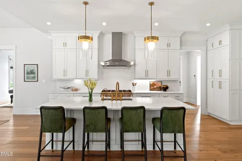 a view of a dining room with furniture a chandelier and wooden floor
