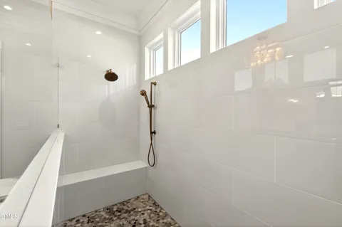 a bathroom with a sink vanity granite shower and a mirror