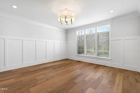 a large kitchen with stainless steel appliances granite countertop a sink and wooden floor