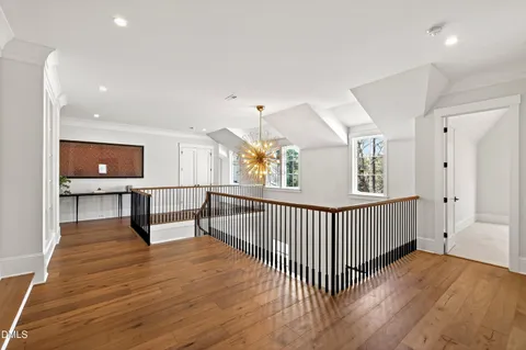 a front view of a house with a yard and potted plants