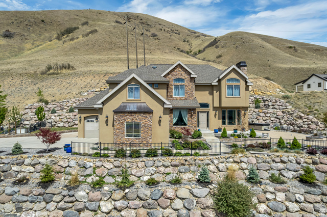2543 East 700 South Springville, UT 84663 - Photo 1 of 73 Craftsman-style house featuring stucco siding, stone siding, a fenced front yard, and a mountain view