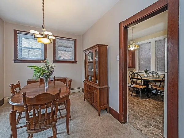 a dining room with furniture and chandelier kitchen view