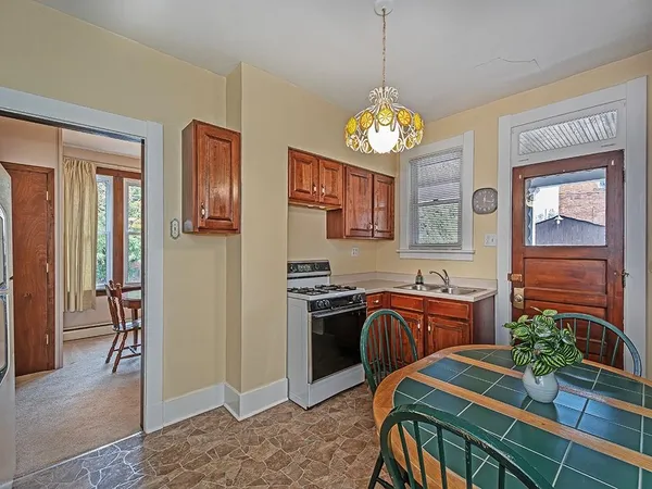 a view of a dining room and kitchen with a chandelier