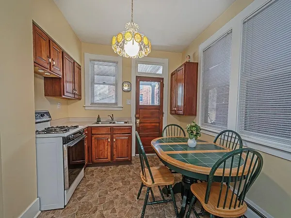 a kitchen with granite countertop a sink and a stove