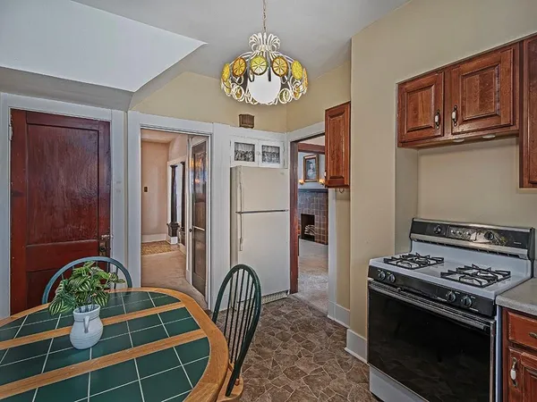 a kitchen with stainless steel appliances granite countertop a stove a refrigerator and a dining table