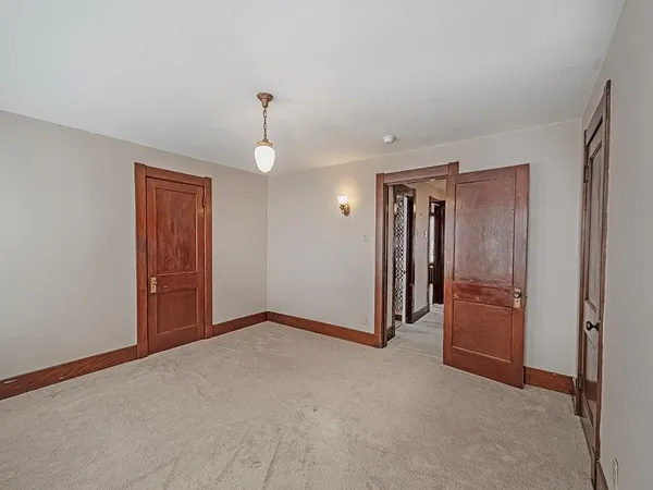 a view of an empty room with a bathroom