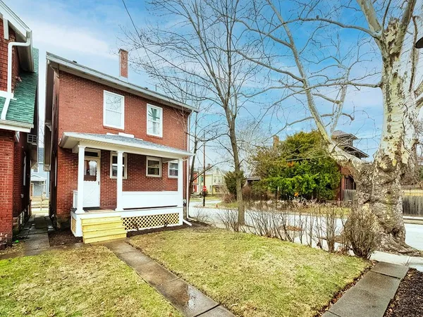 a front view of a house with a yard