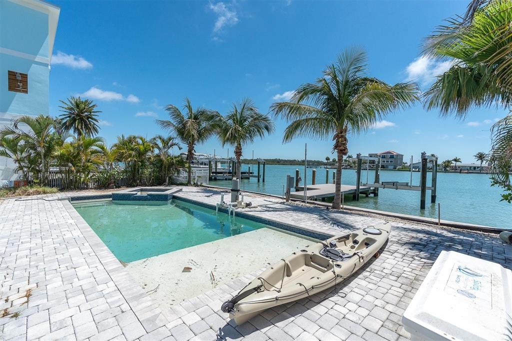 575 Crystal Drive Madeira Beach, FL 33708 - Photo 12 of 16 a view of a backyard with a patio