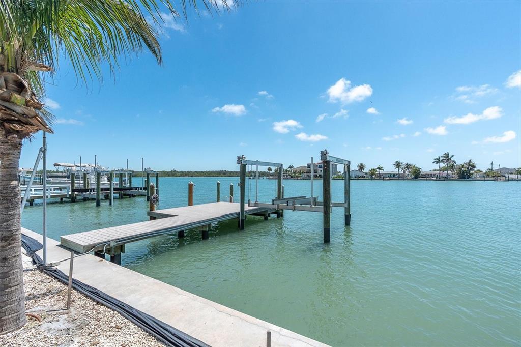 575 Crystal Drive Madeira Beach, FL 33708 - Photo 14 of 16 a view of a lake with boats and palm trees