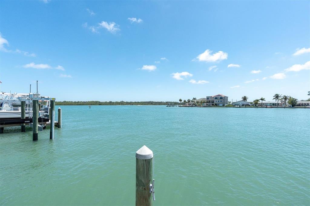 575 Crystal Drive Madeira Beach, FL 33708 - Photo 16 of 16 a view of a lake with table and chairs