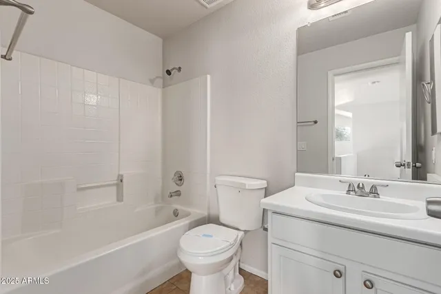 a bathroom with a sink toilet vanity and shower
