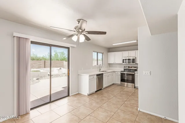 a view of a kitchen with a sink and a window